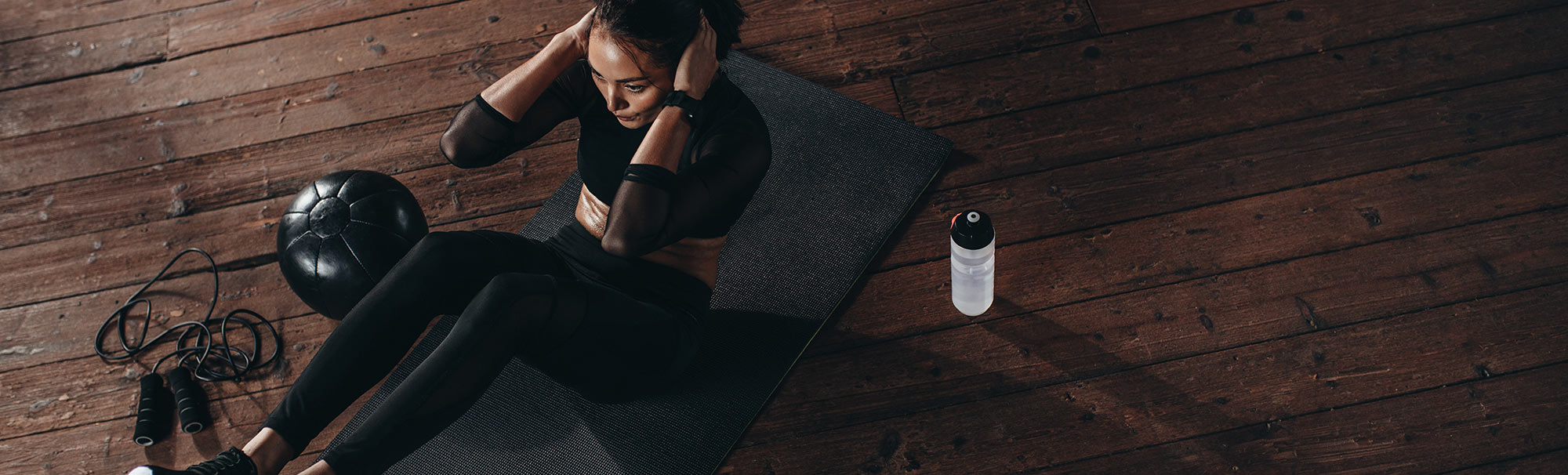 Female athlete performing sit-ups, representing the clean performance and purity guaranteed by Proven4 NSF Certified supplements.
