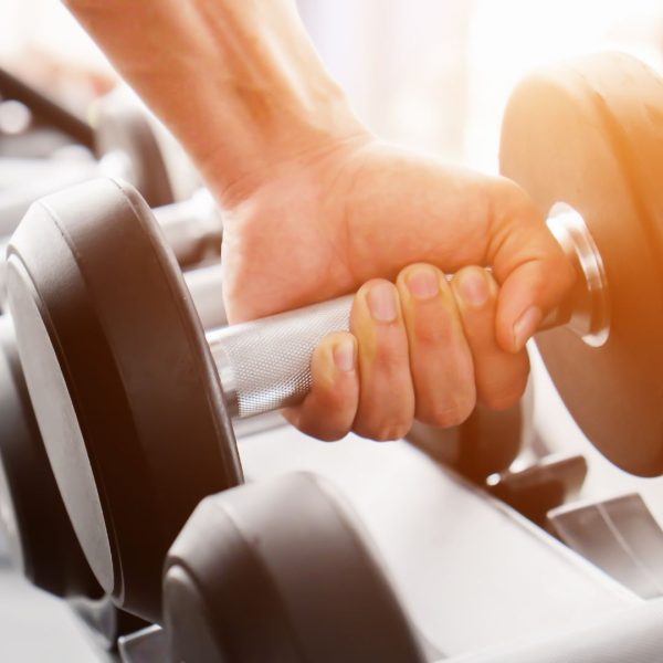 close-up of hand lifting weights